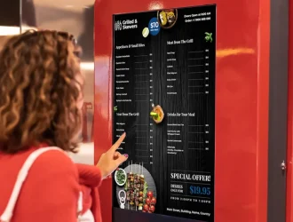 Woman self ordering from kiosk