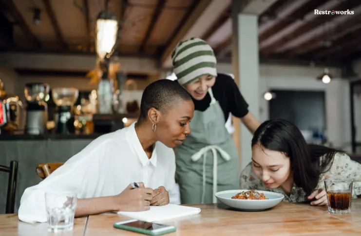 3 customers smelling food in a restaurant