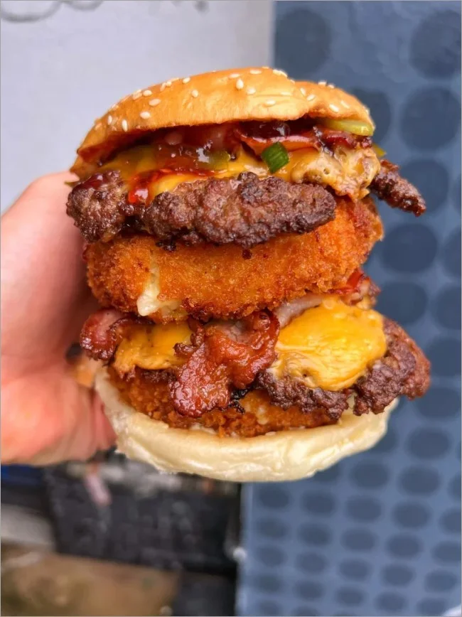 Photo of a burger customer with the hashtag #BestBurgerInTown.