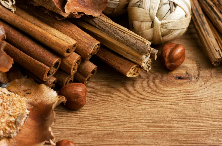 A table that has cinnamon sticks and other spices 