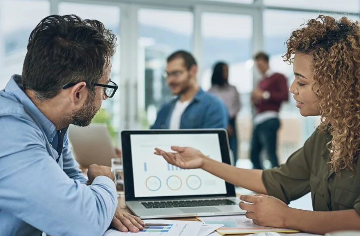 2 people analyzing metrics