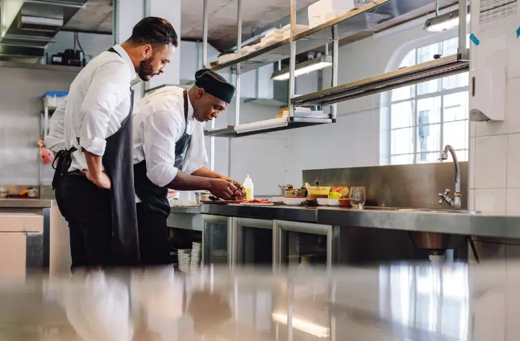 2 chefs preparing food