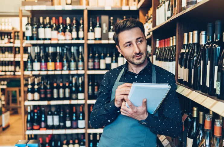 A man counting bar inventory