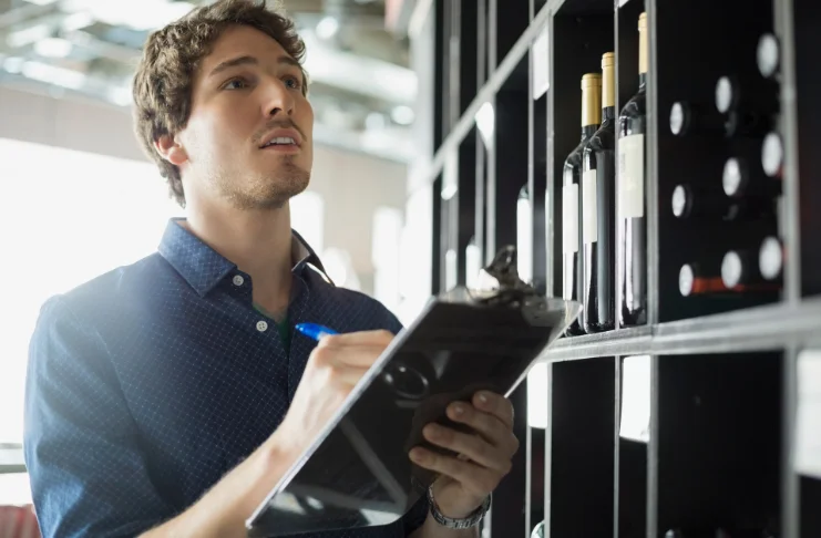 A man doing wine inventory