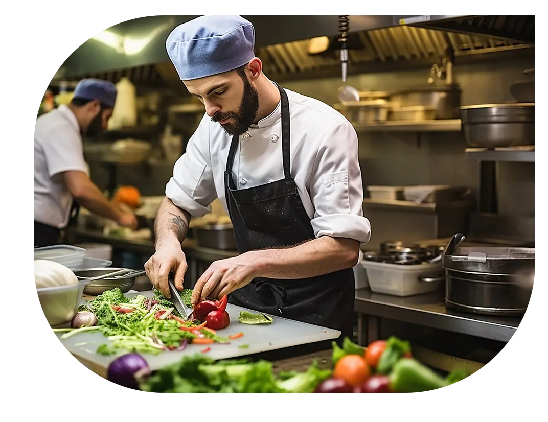 Kitchen staff cutting vegetables
