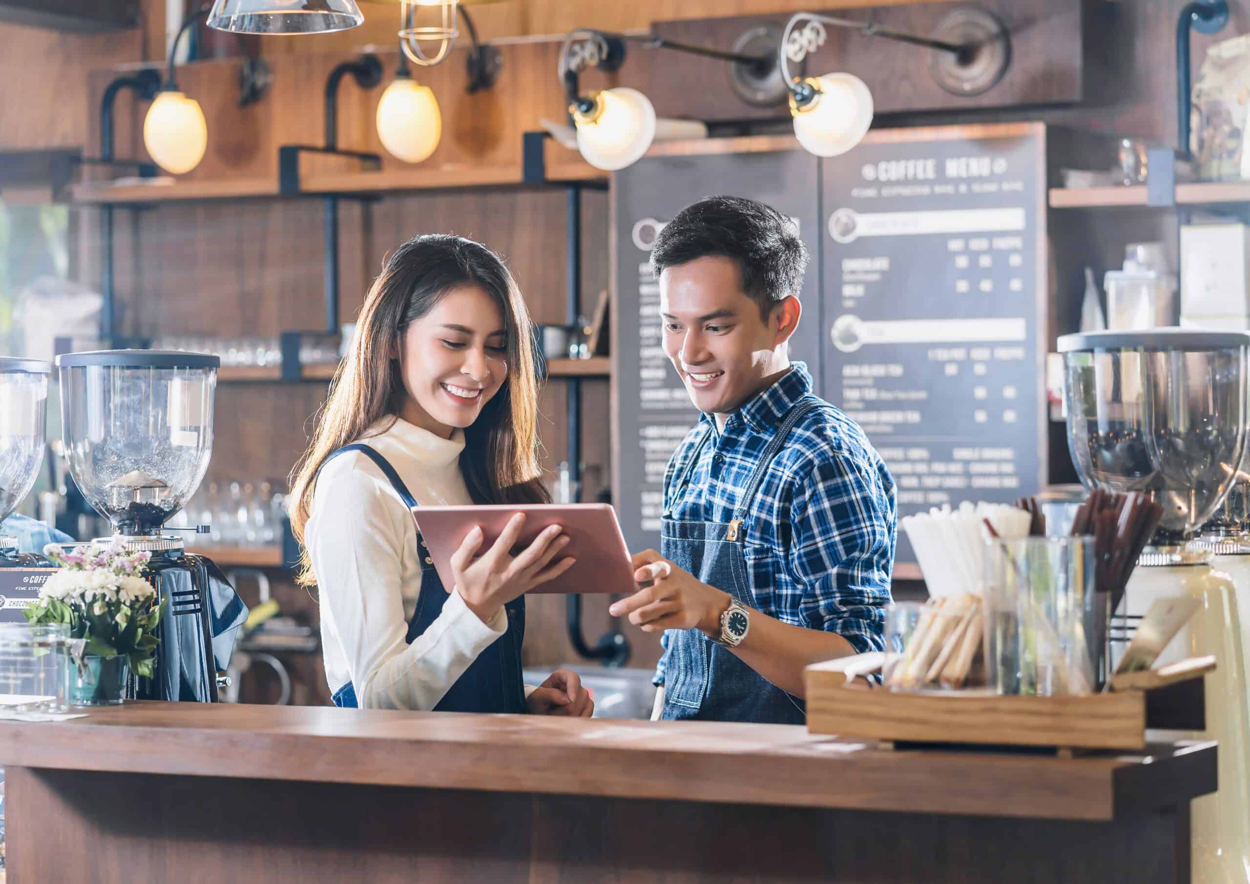 Cafe staff using tablet ordering system
