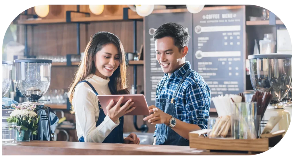 Cafe staff using tablet ordering system