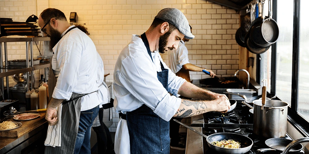 Restaurant kitchen staff working on dishes