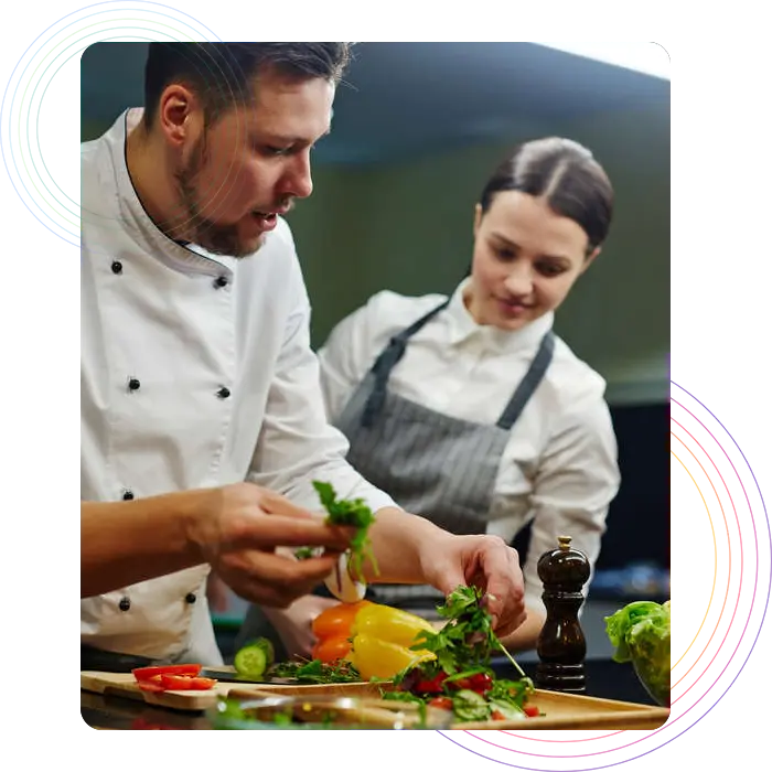 Two chefs preparing a dish